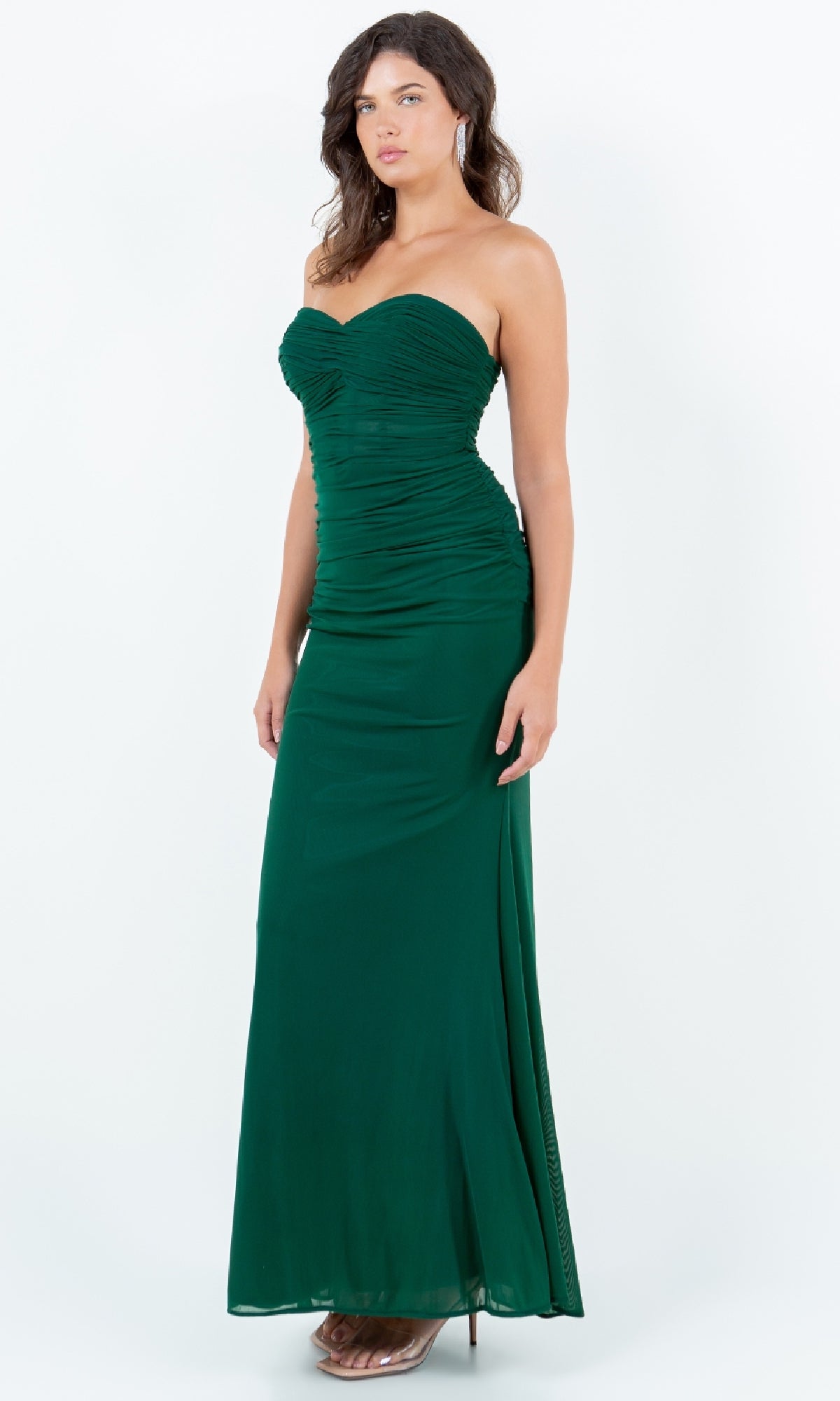 A woman models the Strapless Green Prom Gown: Cinderella Couture 8242J, a floor-length emerald dress with a sweetheart neckline and ruched detailing, against a plain white background.